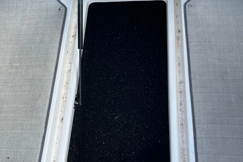 Slide: The Image of Storage compartment of 2021 Regal 2300 Bowrider boat, featuring textured flooring. - 13
