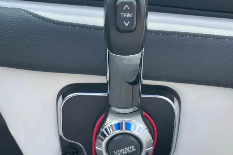 Slide: The Image of Close-up of 2021 Regal 2300 Bowrider boat throttle control with trim button. - 14