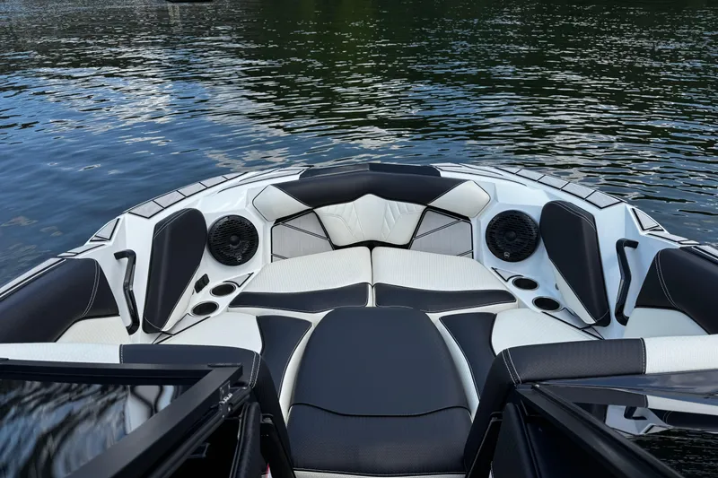Slide: The Image of 2024 Centurion Fi23 boat interior with black and white seating, speakers, and cup holders. - 11