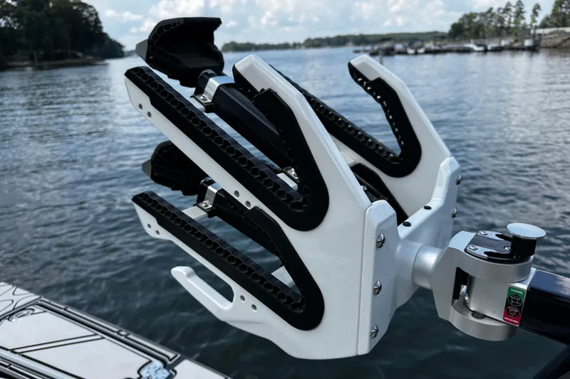 Slide: The Image of 2024 Centurion Fi23 boat with advanced wakeboard rack on a serene lake. - 13