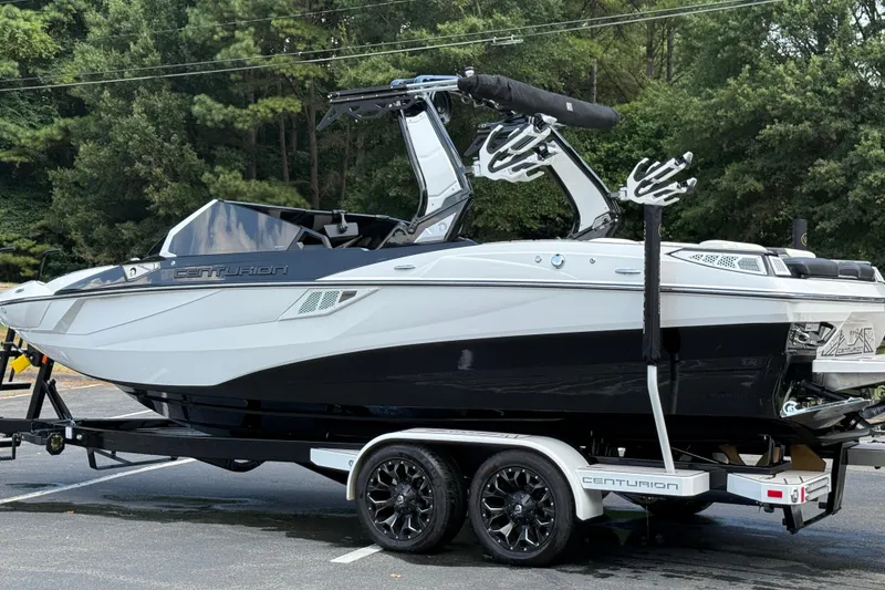 Slide: The Image of 2024 Centurion Fi23 boat on trailer, sleek design, parked outdoors. - 17