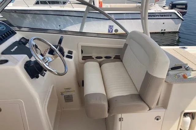 Slide: The Image of 2014 Grady-White Freedom 285 boat interior with steering wheel and seating. - 15