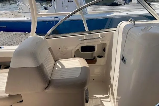 Slide: The Image of 2014 Grady-White Freedom 285 boat interior with seating and control panel. - 16
