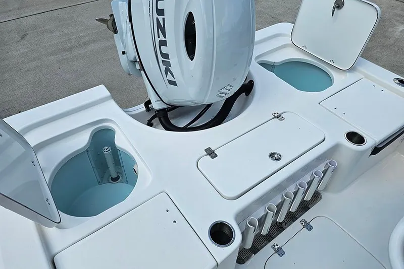 Slide: The Image of 2026 Sea Pro 230 Bay boat deck with Suzuki engine and storage compartments. - 10