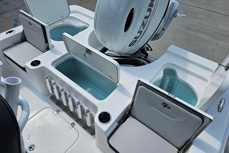 Slide: The Image of 2026 Sea Pro 230 Bay boat interior with storage compartments and Suzuki engine. - 11