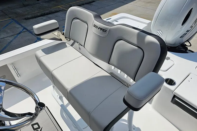 Slide: The Image of 2026 Sea Pro 230 Bay boat interior with cushioned seating and steering wheel. - 12