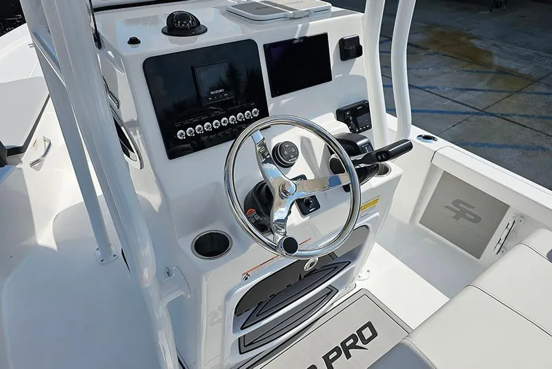 Slide: The Image of 2026 Sea Pro 230 Bay boat console with steering wheel and navigation controls. - 13