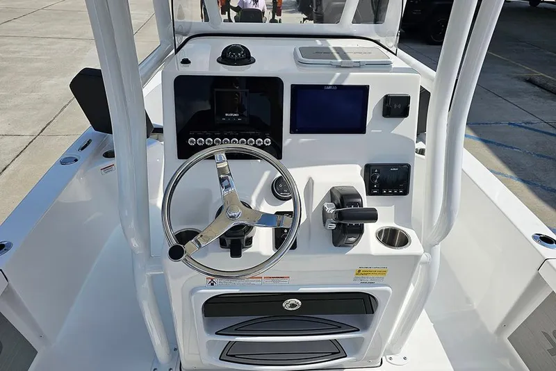 Slide: The Image of 2026 Sea Pro 230 Bay boat console with steering wheel and navigation controls. - 14