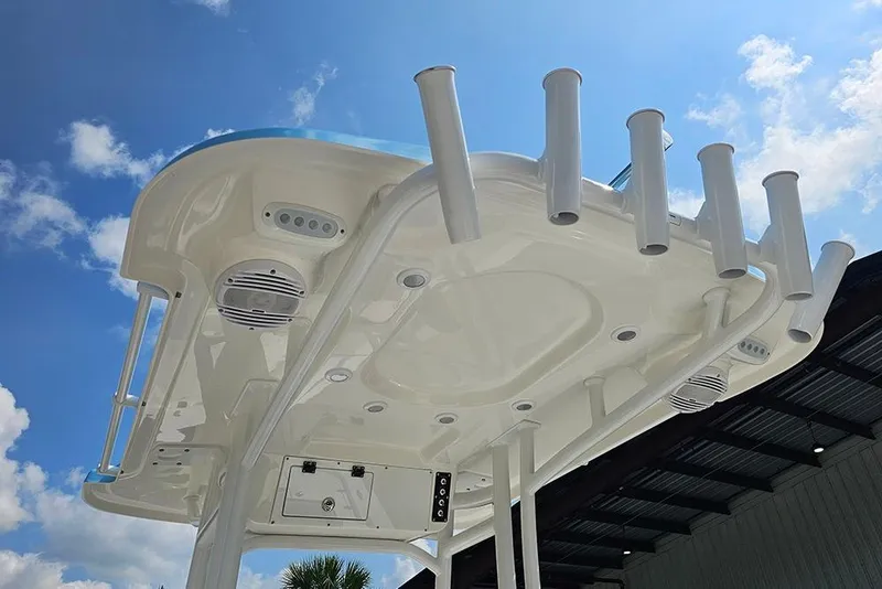 Slide: The Image of 2026 Sea Pro 230 Bay boat top view with rod holders and speakers under blue sky. - 16