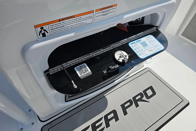 Slide: The Image of 2026 Sea Pro 230 Bay boat storage compartment with warning labels and QR code. - 17