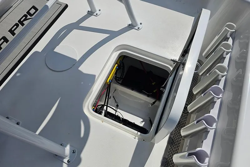 Slide: The Image of 2026 Sea Pro 230 Bay boat deck with open storage compartment and rod holders. - 19