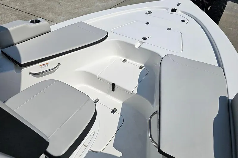 Slide: The Image of 2026 Sea Pro 230 Bay boat interior with cushioned seating and storage compartments. - 24