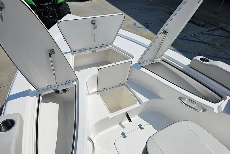 Slide: The Image of 2026 Sea Pro 230 Bay boat with open storage compartments and seating. - 26