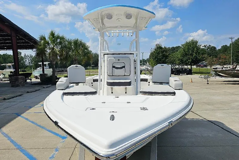 Slide: The Image of 2026 Sea Pro 230 Bay boat in marina, clear sky, palm trees in background. - 3