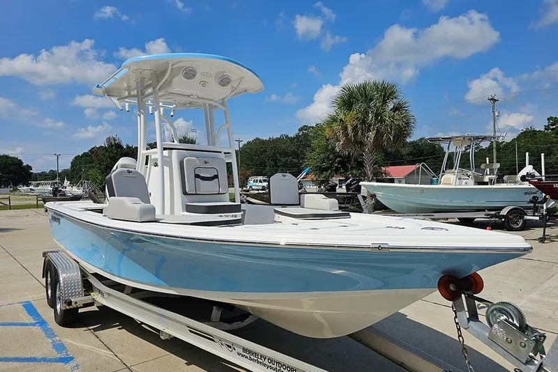 Slide: The Image of 2026 Sea Pro 230 Bay boat on trailer, under clear blue sky. - 4