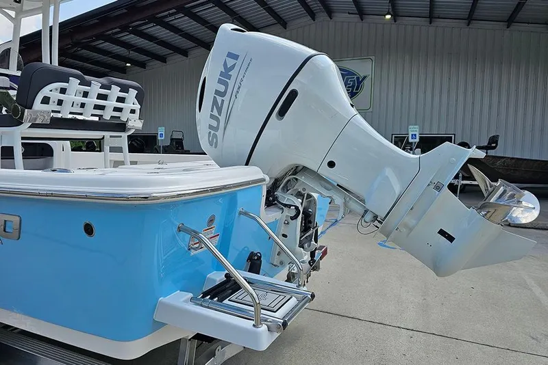 Slide: The Image of 2026 Sea Pro 230 Bay boat with Suzuki outboard motor, docked under a metal roof. - 8