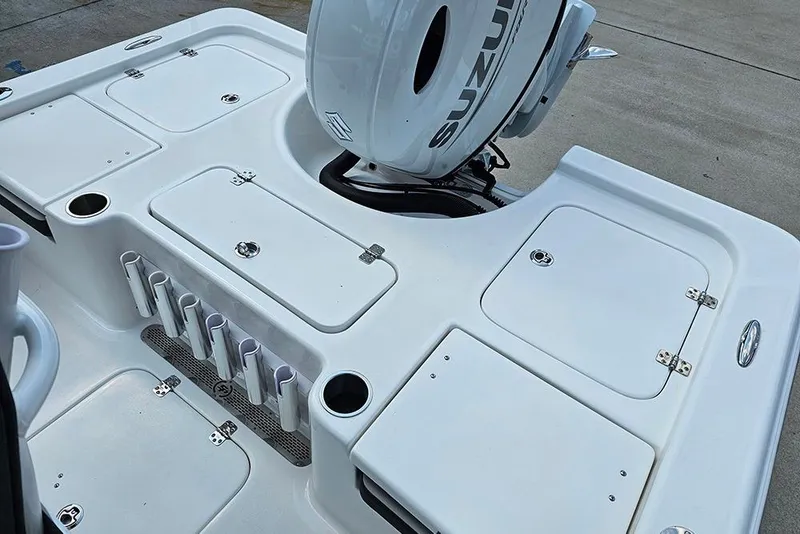 Slide: The Image of 2026 Sea Pro 230 Bay boat deck with storage compartments and Suzuki outboard motor. - 9