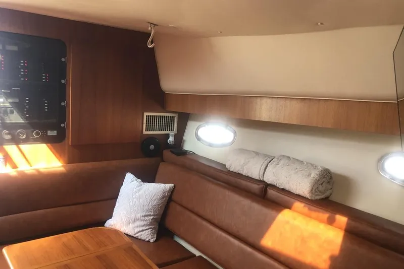 Slide: The Image of 1998 Tiara Yachts 3700 Open interior with leather seating and wooden accents. - 13