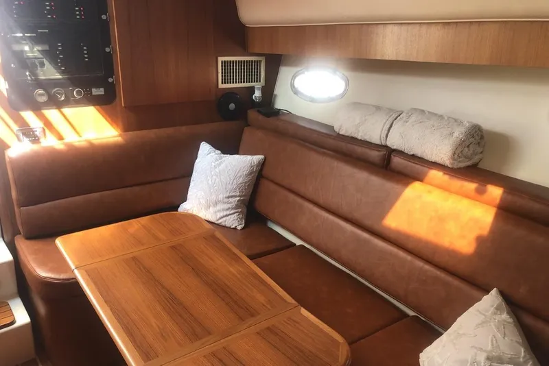 Slide: The Image of Luxurious interior of 1998 Tiara Yachts 3700 Open with leather seating and wooden table. - 14