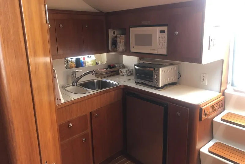 Slide: The Image of 1998 Tiara Yachts 3700 Open galley with sink, microwave, and toaster oven. - 18