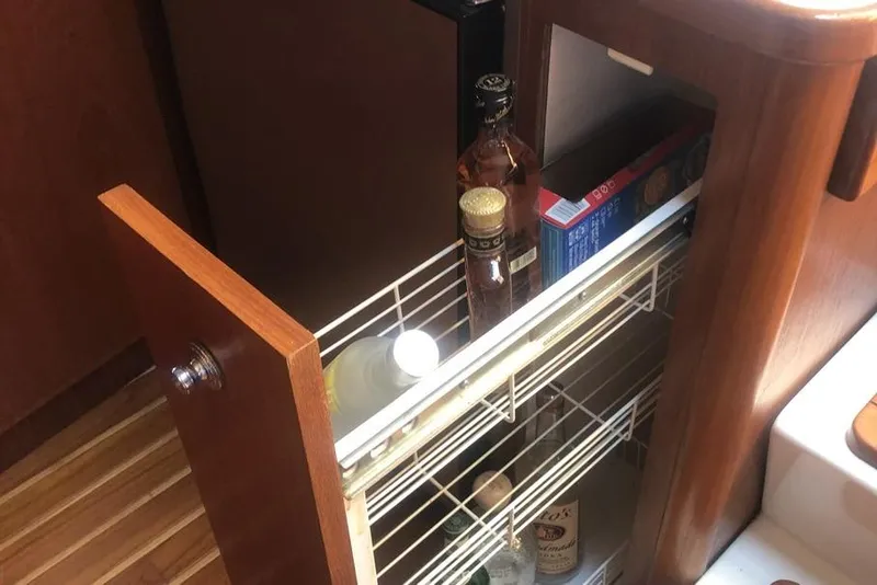 Slide: The Image of 1998 Tiara Yachts 3700 Open interior with pull-out pantry and wooden cabinetry. - 19