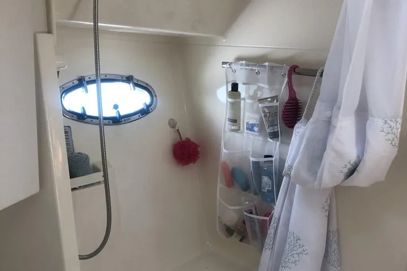 Slide: The Image of Bathroom interior of 1998 Tiara Yachts 3700 Open with toiletries and porthole window. - 24