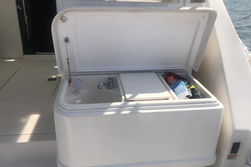 Slide: The Image of 1998 Tiara Yachts 3700 Open boat sink and storage compartment on deck. - 28