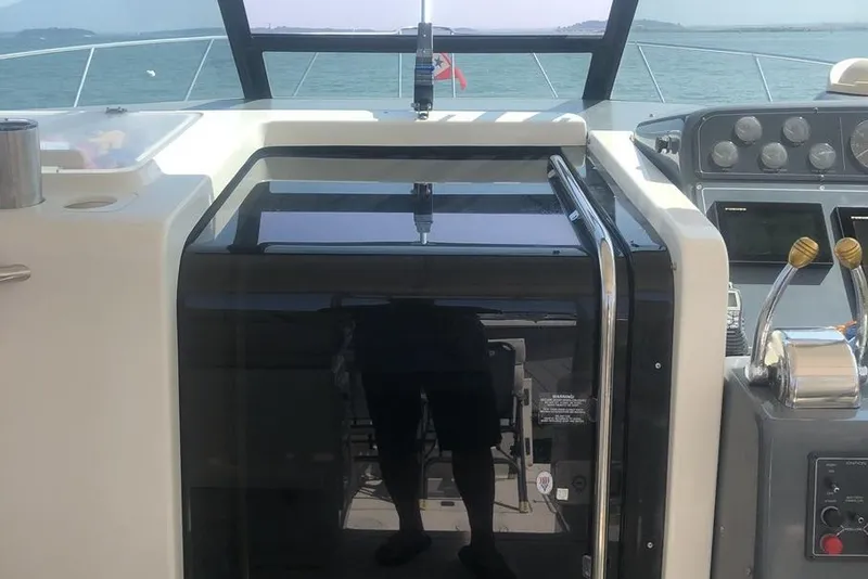 Slide: The Image of 1998 Tiara Yachts 3700 Open cockpit with control panel and ocean view. - 31