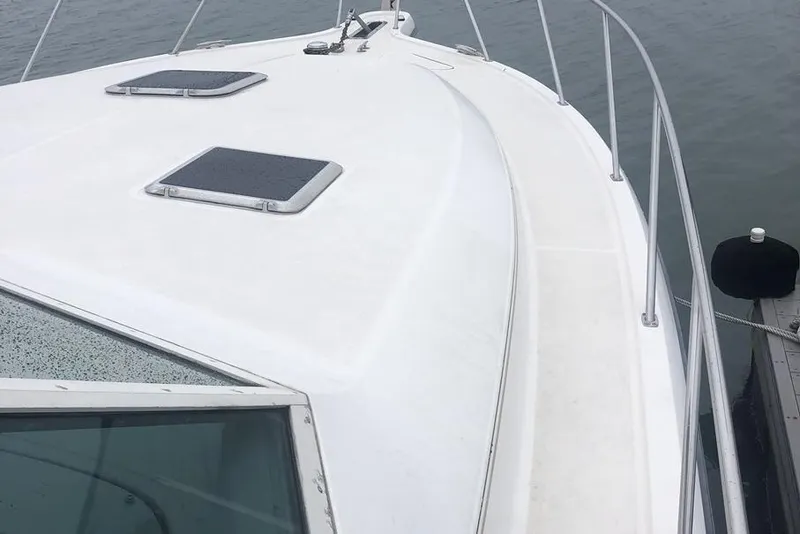 Slide: The Image of 1998 Tiara Yachts 3700 Open boat deck with railing and hatches. - 32