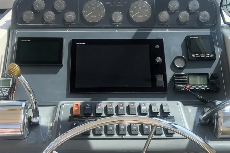 Slide: The Image of 1998 Tiara Yachts 3700 Open dashboard with navigation and control instruments. - 4