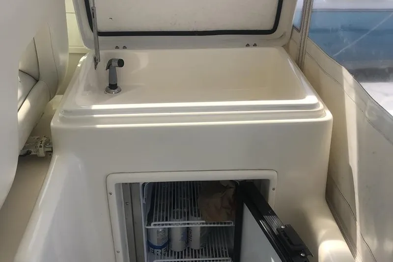 Slide: The Image of 1998 Tiara Yachts 3700 Open interior with sink and mini fridge. - 6