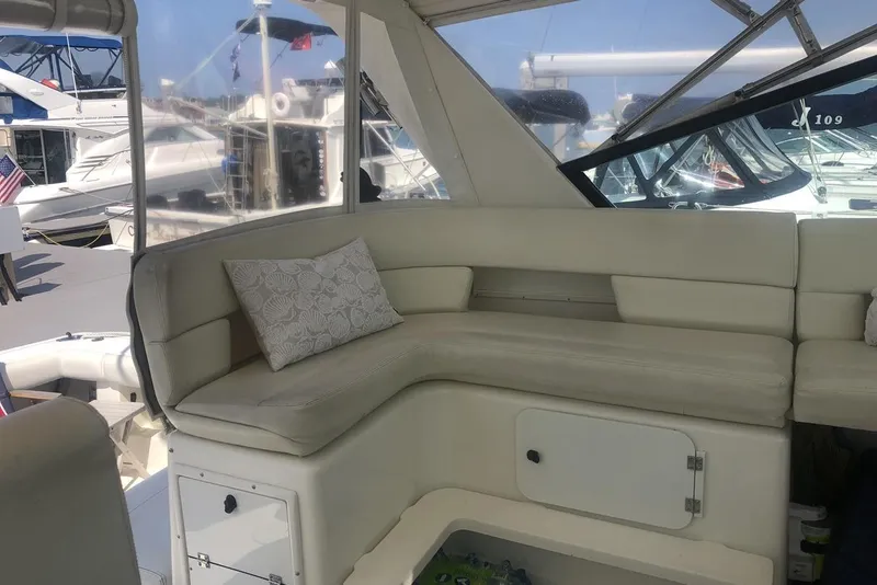 Slide: The Image of 1998 Tiara Yachts 3700 Open interior with cushioned seating and decorative pillow. - 7