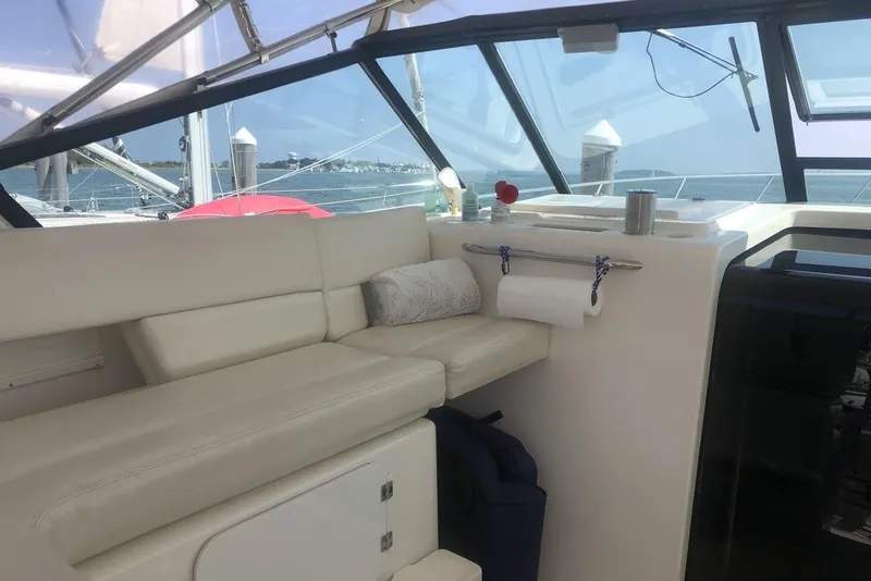 Slide: The Image of 1998 Tiara Yachts 3700 Open interior with white seating and ocean view. - 8