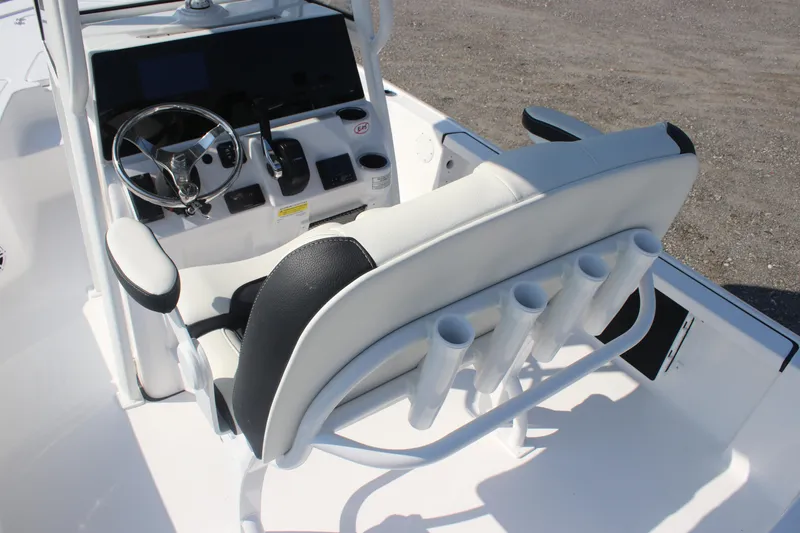Slide: The Image of 2026 Tidewater 2110 Bay Max boat interior with steering wheel and rod holders. - 13