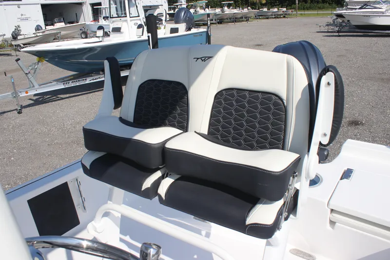 Slide: The Image of 2026 Tidewater 2110 Bay Max boat seats with black and white upholstery, parked outdoors. - 9
