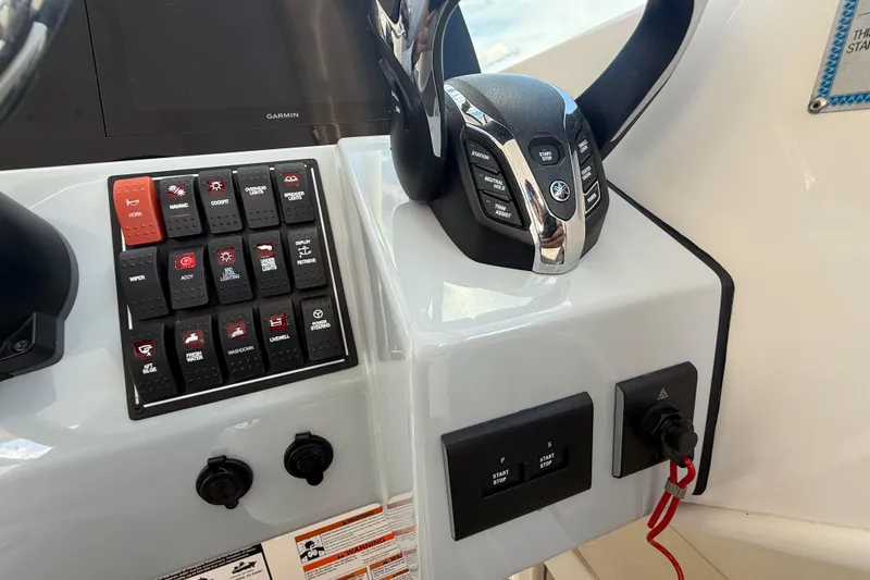 Slide: The Image of 2024 Pursuit DC 266 Dual Console dashboard with control panel and steering wheel. - 12