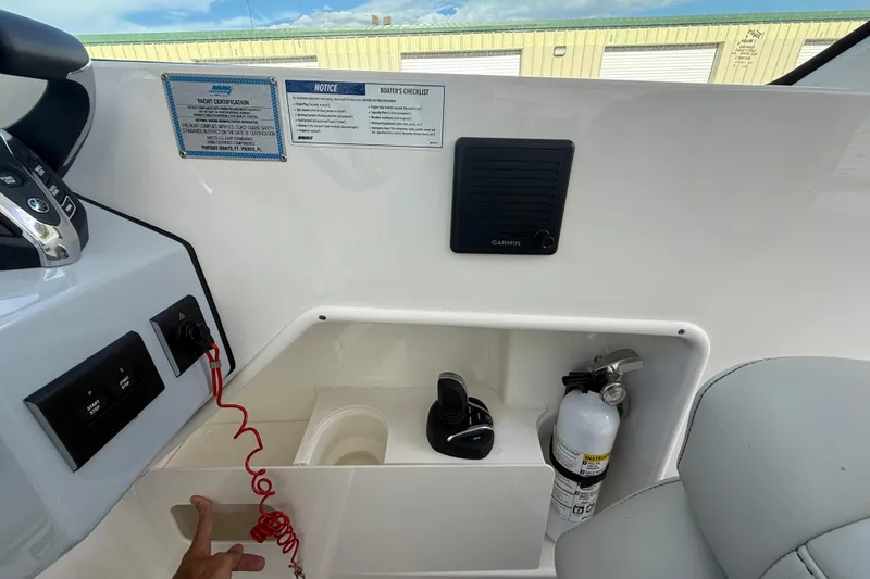 Slide: The Image of 2024 Pursuit DC 266 Dual Console dashboard with controls, fire extinguisher, and Garmin device. - 13