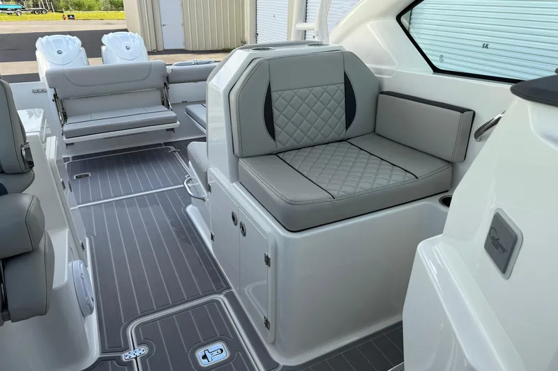 Slide: The Image of 2024 Pursuit DC 266 Dual Console boat interior with gray seating and modern design. - 14