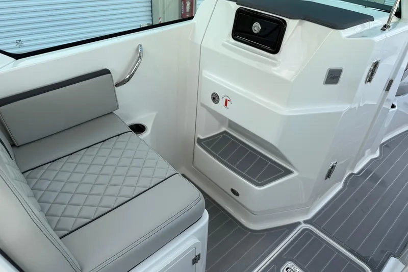 Slide: The Image of 2024 Pursuit DC 266 Dual Console interior with gray seating and sleek design. - 15