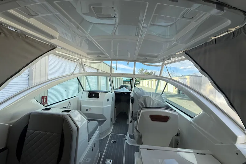 Slide: The Image of 2024 Pursuit DC 266 Dual Console interior with modern seating and sleek design. - 20