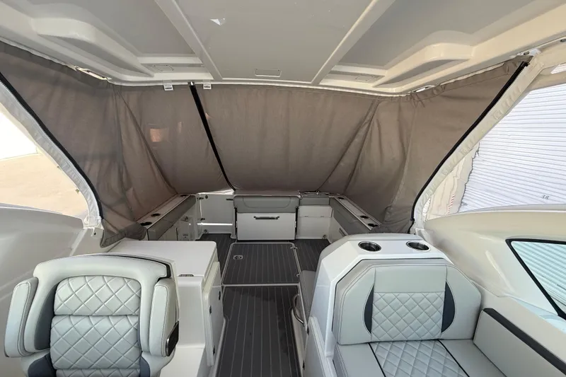 Slide: The Image of 2024 Pursuit DC 266 Dual Console interior with seating and protective canopy. - 21