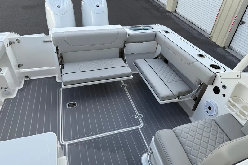Slide: The Image of 2024 Pursuit DC 266 Dual Console boat interior with gray seating and flooring. - 22