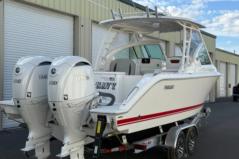 Slide: The Image of 2024 Pursuit DC 266 Dual Console boat with twin Yamaha 200 engines on a trailer. - 27
