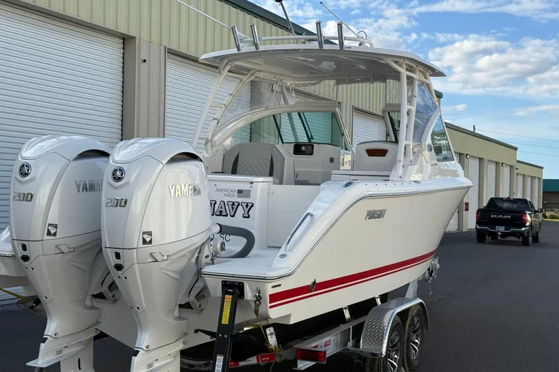 Slide: The Image of 2024 Pursuit DC 266 Dual Console boat with twin Yamaha 200 engines on a trailer. - 28