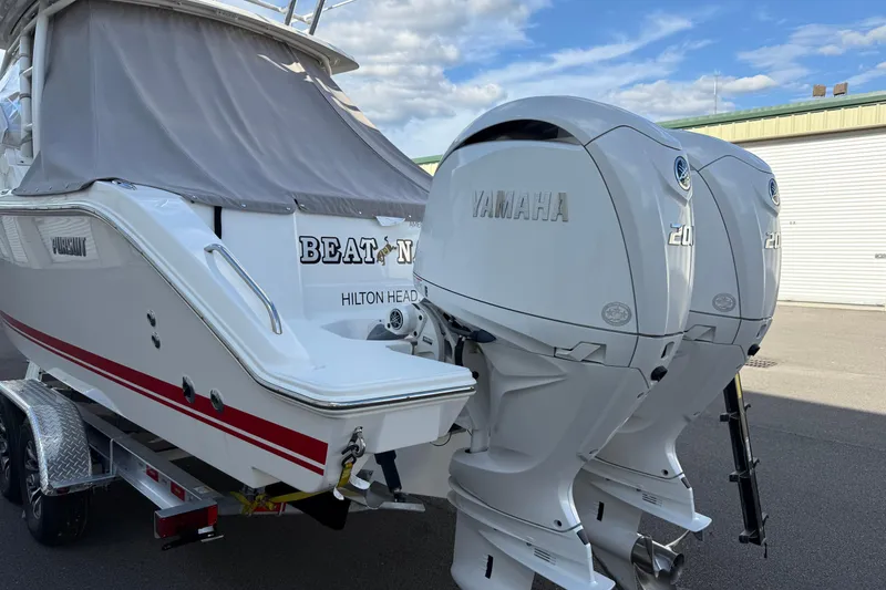 Slide: The Image of 2024 Pursuit DC 266 Dual Console boat with twin Yamaha 200 engines, docked at Hilton Head. - 3