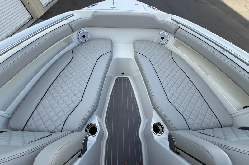 Slide: The Image of 2024 Pursuit DC 266 Dual Console boat interior with quilted seating and sleek design. - 33