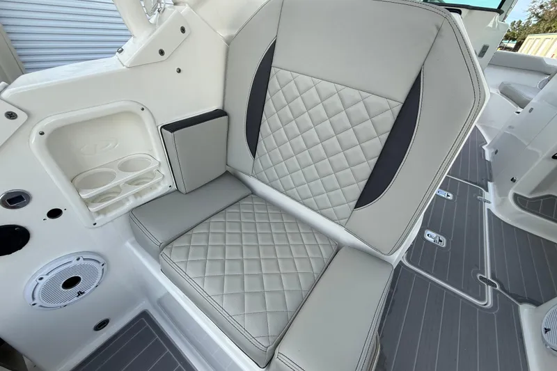 Slide: The Image of 2024 Pursuit DC 266 Dual Console boat seat with quilted upholstery and cup holders. - 35