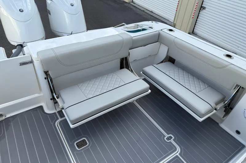 Slide: The Image of 2024 Pursuit DC 266 Dual Console boat with foldable seating and twin engines. - 38