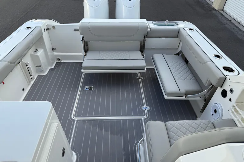 Slide: The Image of 2024 Pursuit DC 266 Dual Console boat interior with gray seating and deck. - 39