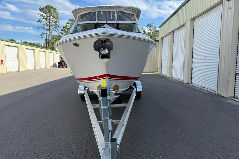 Slide: The Image of 2024 Pursuit DC 266 Dual Console boat on trailer near storage units. - 43